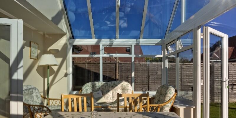 conservatory with glass windows and dining room